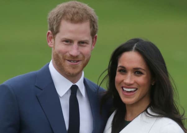 Prince Harry standing with his fiancÃ©e US actress Meghan Markle. Picture: Getty Images