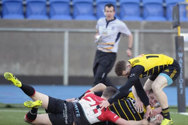 Ruaridh Knott of Melrose failed to get over the line as Sam Yawayawa and Scott Peffers held him up. Photograph: Neil Hanna