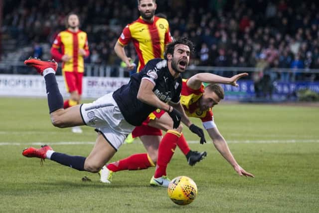 Dundee's Sofien Moussa goes down in the box after a challenge from Partick Thistle's Danny Devine. Picture: SNS/Kenny Smith