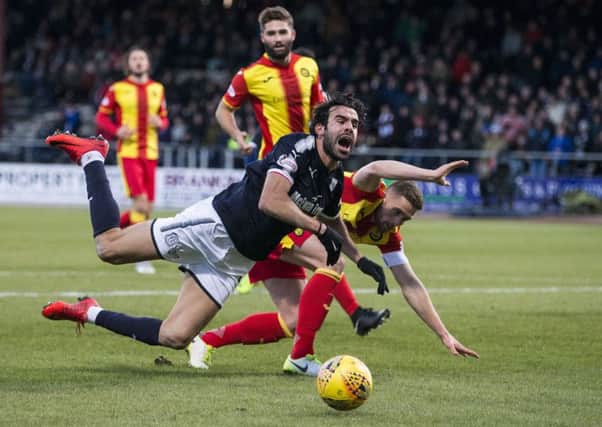 Dundee's Sofien Moussa goes down in the box after a challenge from Partick Thistle's Danny Devine. Picture: SNS/Kenny Smith