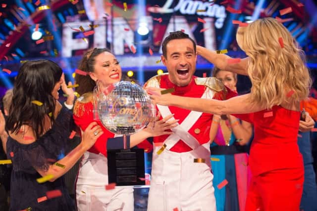 Claudia Winkleman (left) and Tess Daly (right) present Katya Jones and Joe McFadden with the glitterball trophy.