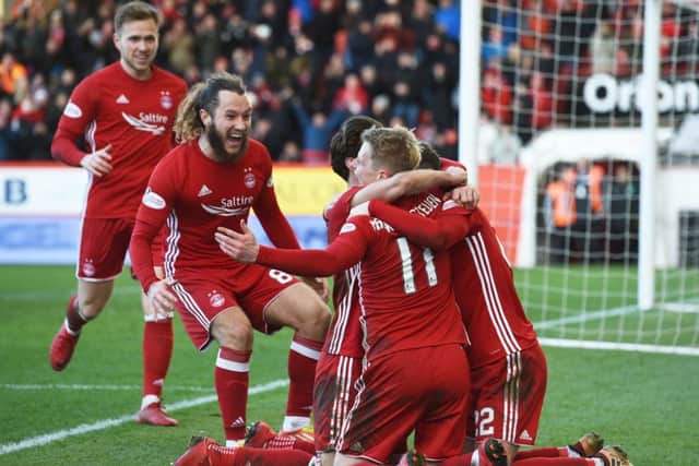 Aberdeen players flock round No 11 Gary Mackay-Steven, who scored an impressive hat-trick at Pittodrie on Saturday. Picture: SNS