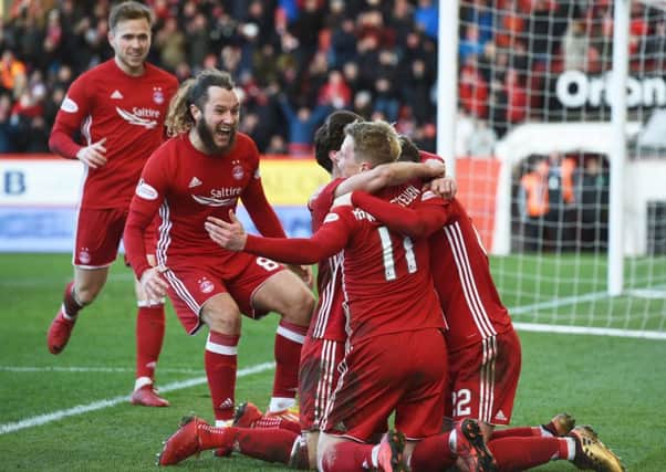 Aberdeen players flock round No 11 Gary Mackay-Steven, who scored an impressive hat-trick at Pittodrie on Saturday. Picture: SNS