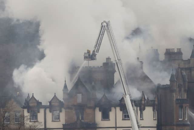 Firefighters at the scene following a fire at the Cameron House Hotel . Picture: PA