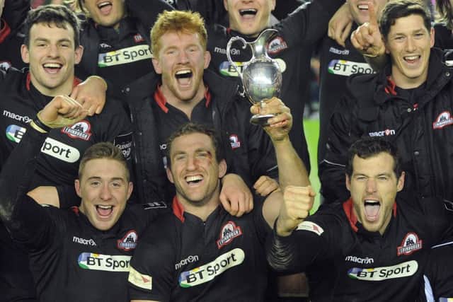 The victorious Edinburgh players celebrate with the trophy after defeating Glasgow in 2015. Picture: Neil Hanna