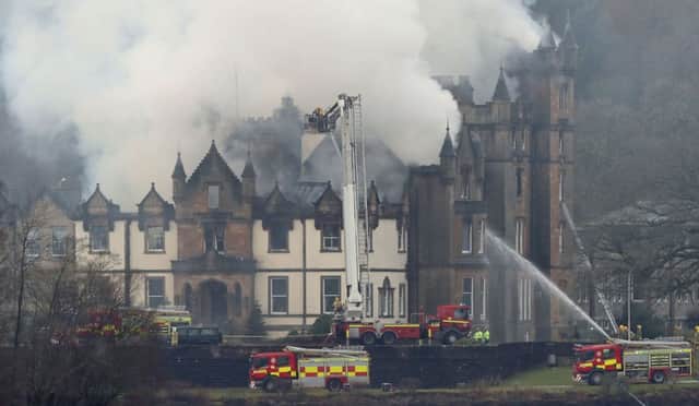 Firefighters at the scene following a fire at the Cameron House Hotel. Picture: PA