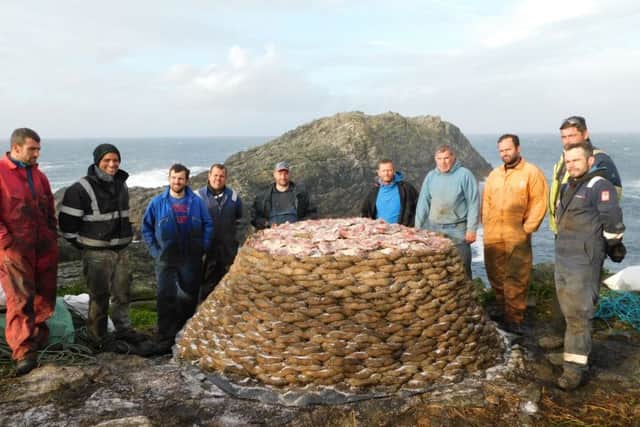 The guga hunters with their stack of 2,000 salted guga at the end of their two-week hunting trip. PIC: MacTV/BBC Alba.