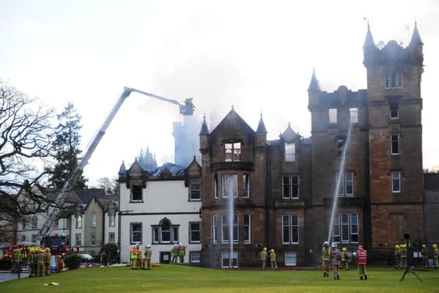 Firefighters at the scene following the fire at the Cameron House Hotel. Picture: Mike Gibbons/PA Wire