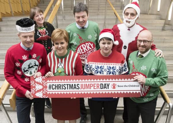 Back row, from the left: Childcare minister Maree Todd, Scottish Parliament Presiding Officer Ken Macintosh, Labour MSP Anas Sarwar and (front row, from the left) Lib Dem leader Willie Rennie, First Minister Nicola Sturgeon, Scottish Tory leader Ruth Davidson and Scottish Greens co-leader Patrick Harvey wear their Christmas jumpers for a good cause. (Picture: PA)
