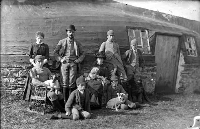 Gamekeepers by their home made from an upturned boat. PIC: The Johnston Collection/The Wick Society.
