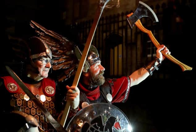The opening event of Edinburgh's Hogmanay celebrations starts with the annual Torchlight Procession, as thousands of torch carriers led by Shetland's Up Helly Aa' Vikings. Picture: Jane Barlow/PA Wire