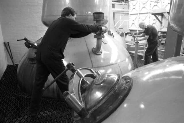 Men working on the whisky stills at the Rosebank distillery ahead of its closure in February 1993. Picture: TSPL