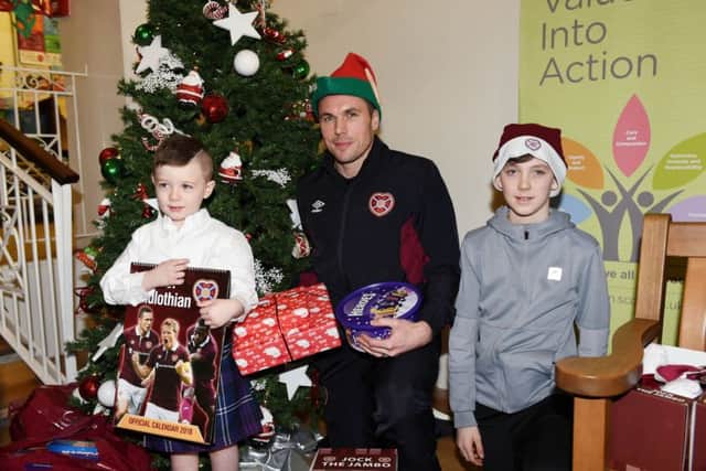 Hearts' Don Cowie is pictured with Quinn Martin (4) and Shayne McKenzie (12) on a visit to Edinburgh's Royal Hospital for Sick Children. Picture: Craig Foy/SNS
