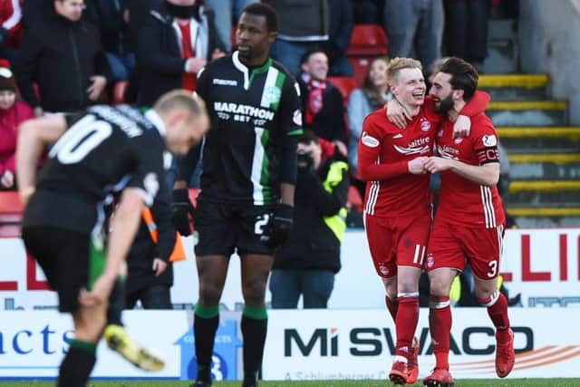 Efe Ambrose looks disgusted as Gary Mackay-Steven (left) celebrates a goal with teammate Graeme Shinnie. Picture: SNS Group