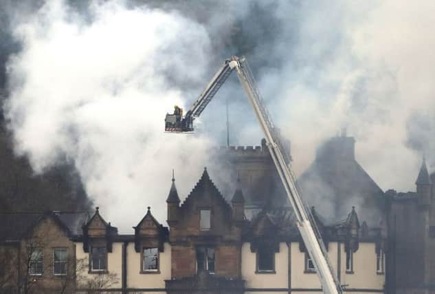 Firefighters at the scene following a fire at Cameron House on the banks of Loch Lomond. Picture: PA