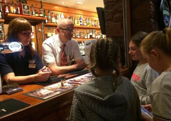School pupils discuss marine plastic pollution with staff at the Royal Hotel in Ullapool, which has become the country's first village to outlaw plastic drinking straws. Picture: Noel Hawkins