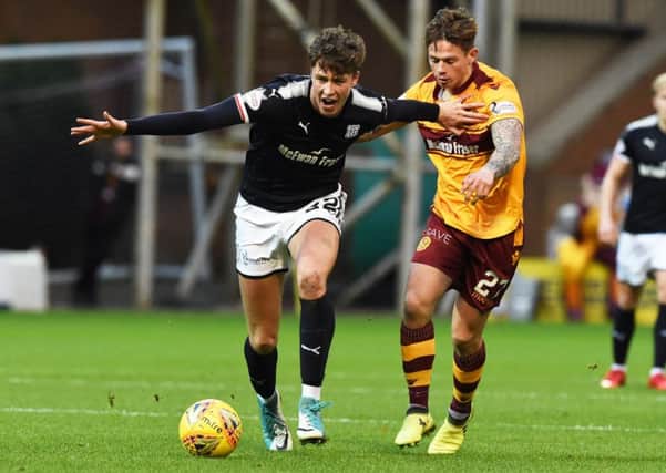 Dundee's Jack Hendry holds off Motherwell's Craig Tanner. Picture: SNS/Paul Devlin
