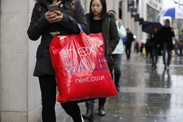 Shoppers carrying purchases from the Boxing Day sales in Manchester. Picture: PA Wire