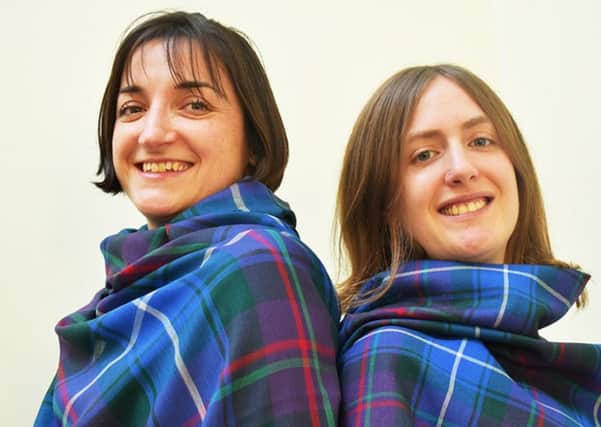 Jennie Chinembiri (left) and Eleri Birkhead with the official Church of Scotland tartan. Picture: PA