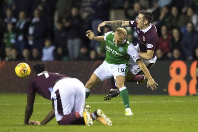 Dylan McGeouch and Jamie Walker tussle in the last derby at Easter Road while Isma watches on. Picture: SNS Group