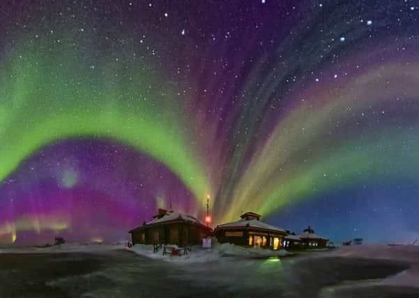 Bursting with colour in the night, these aren't fireworks but aurora lighting up the northern skies in Greenland. Picture: SWNS/Juan Carlos Casado