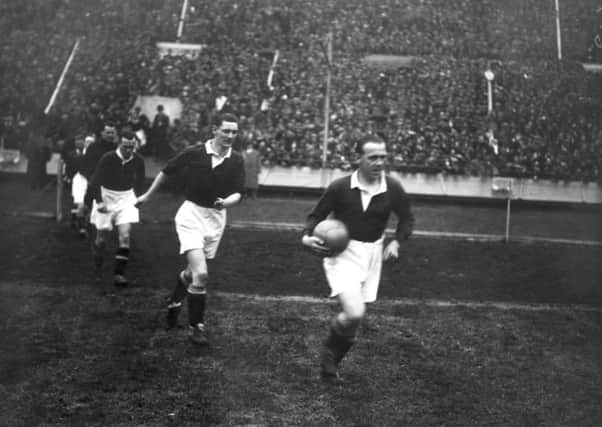 31st March 1928:  The Scottish captain Jimmy McMullan leads out his team for the International soccer match between England and Scotland. Alex James scored twice and Scotland won the game 5 - 1.  (Photo by Davis/Topical Press Agency/Getty Images)