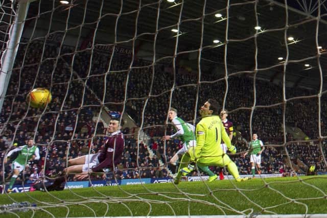 Hibs striker Oli Shaw, centre, watches his seventh-minute effort bounce down off the bar and over the line but assistant referee Sean Carr did not give the goal. Picture: Paul Devlin/SNS