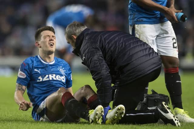 Rangers midfielder Ryan Jack receives treatment for a knee injury. Picture: SNS