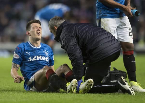 Rangers midfielder Ryan Jack receives treatment for a knee injury. Picture: SNS