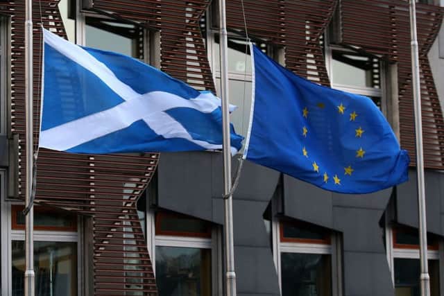 File photo dated 20/12/16 of a Saltire flag and an European Union flag fly outside the Scottish Parliament in Edinburgh. An independent Scotland could be a full member of the European Union by 2023, according to two leading academics. PRESS ASSOCIATION Photo. Issue date: Monday February 20, 2017. Tobias Lock, from the University of Edinburgh, and Kirsty Hughes, of Friends of Europe, said political goodwill in the EU could see Scotland fast-tracked to membership if a second independence referendum delivered a Yes vote. See PA story POLITICS Scotland. Photo credit should read: Andrew Milligan/PA Wire