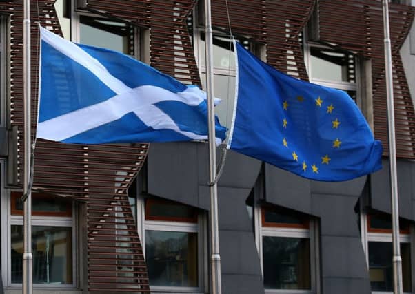 File photo dated 20/12/16 of a Saltire flag and an European Union flag fly outside the Scottish Parliament in Edinburgh. An independent Scotland could be a full member of the European Union by 2023, according to two leading academics. PRESS ASSOCIATION Photo. Issue date: Monday February 20, 2017. Tobias Lock, from the University of Edinburgh, and Kirsty Hughes, of Friends of Europe, said political goodwill in the EU could see Scotland fast-tracked to membership if a second independence referendum delivered a Yes vote. See PA story POLITICS Scotland. Photo credit should read: Andrew Milligan/PA Wire
