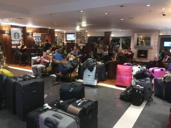 Stranded passengers from the Qatar Airways flight wait in an Edinburgh hotel lobby. Picture: Ian Rutherford