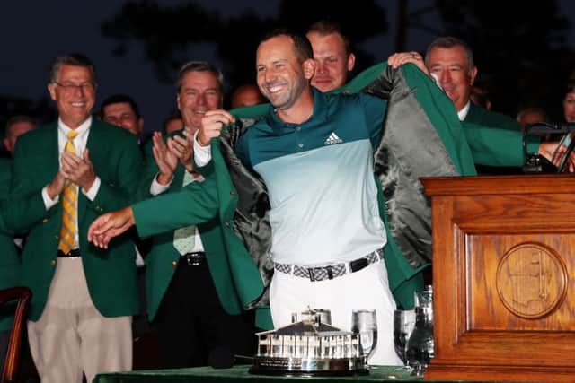 Defending champ Danny Willett presents Sergio Garcia with his green jacket for winning the 2017 Masters. Picture: Rob Carr/Getty Images)