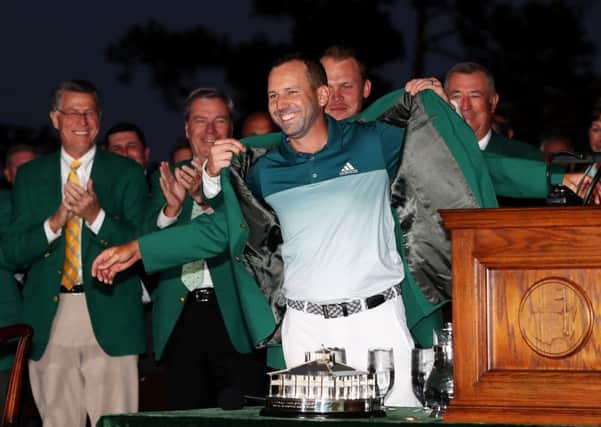 Defending champ Danny Willett presents Sergio Garcia with his green jacket for winning the 2017 Masters. Picture: Rob Carr/Getty Images)