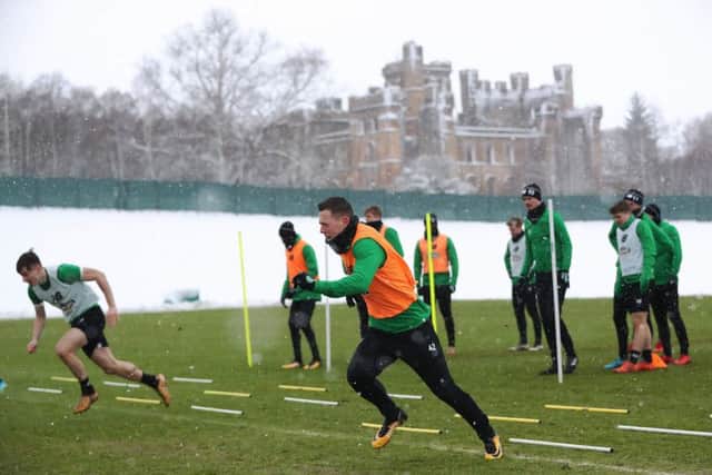 Celtic midfielder Callum McGregor, centre, sprints during training at a snowy Lennoxtown. Picture: Ian MacNicol/Getty Images