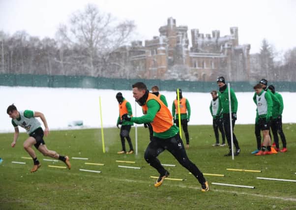 Celtic midfielder Callum McGregor, centre, sprints during training at a snowy Lennoxtown. Picture: Ian MacNicol/Getty Images