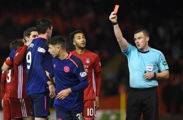Referee John Beaton shows the red card to Hearts' Kyle Lafferty (left). Picture: SNS