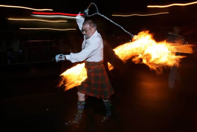 Hogmanay fireball swingers illuminate the streets of Stonehaven. Picture: Getty