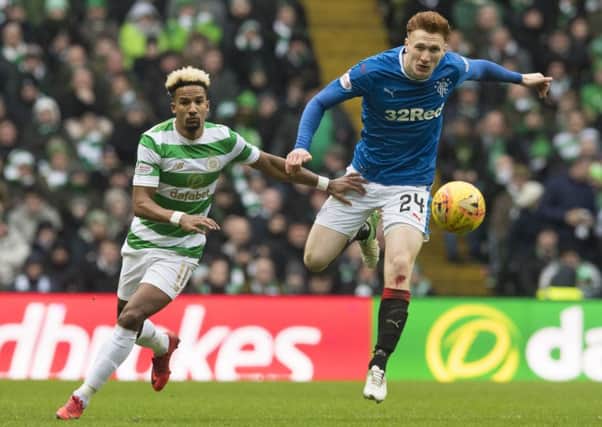 David Bates beats Scott Sinclair to the ball during an impressive performance at Celtic Park. Picture: SNS.