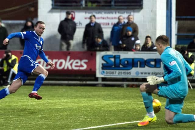 Queen of the South's Chris Kane has a second half shot saved by Dumbarton's Scott Gallacher. Picture: Paul Devlin/SNS
