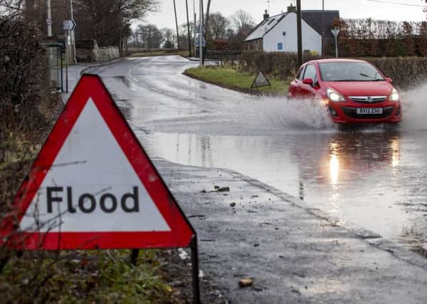 Vehicles pass through a flooded road in Linlithgow, West Lothian as Storm Eleanor hits the UK. Picture: SWNS