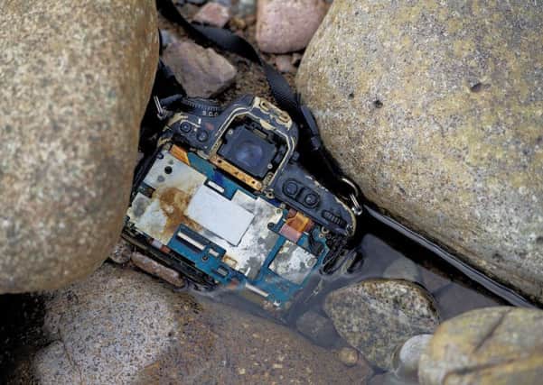 The smashed up Charlie Davidson's Nikon DLSR camera found wedged in rocks, submerged in River Etive, Photo: Peter Sandground/PA Wire