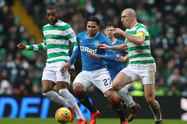 Rangers' Carlos Pena is challenged by Celtic's Scott Brown during Saturday's derby. Picture: Ian MacNicol/Getty Images