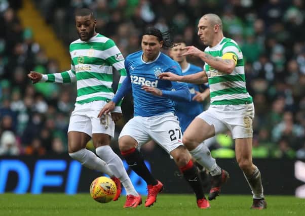 Rangers' Carlos Pena is challenged by Celtic's Scott Brown during Saturday's derby. Picture: Ian MacNicol/Getty Images