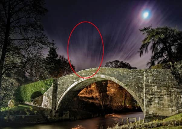 Photographer Scott Wanstall got more than he bargained for after spotting a spooky face of a woman in the clouds above the Brig o'Doon in Ayrshire. Picture: SWNS