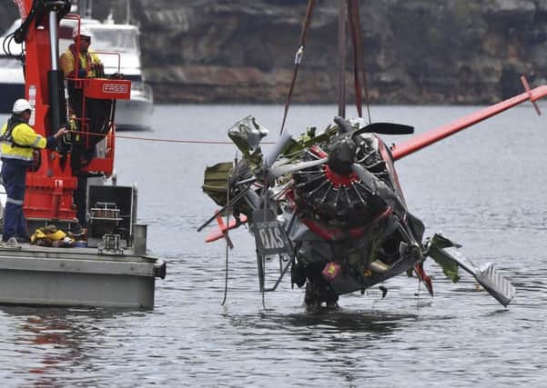 NSW police and salvage personnel work to recover the wreckage of the seaplane (Mick Tsikas/AAP Images via AP)