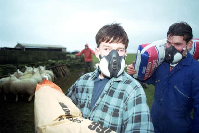 Sumburgh crofters Brian and Kevin Duncan wearing the masks they were given after the Braer oil tanker ran aground at Quendale Bay. Picture: Allan Milligan/TSPL