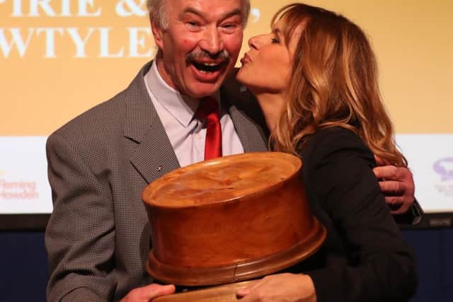 Alan Pirie from James Pirie & Son butchers in Angus is congratulated by host Carol Smillie after winning the World Champion Scotch Pie award. Picture: Andrew Milligan/PA Wire