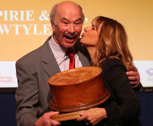 Alan Pirie from James Pirie & Son butchers in Angus is congratulated by host Carol Smillie after winning the World Champion Scotch Pie award. Picture: Andrew Milligan/PA Wire