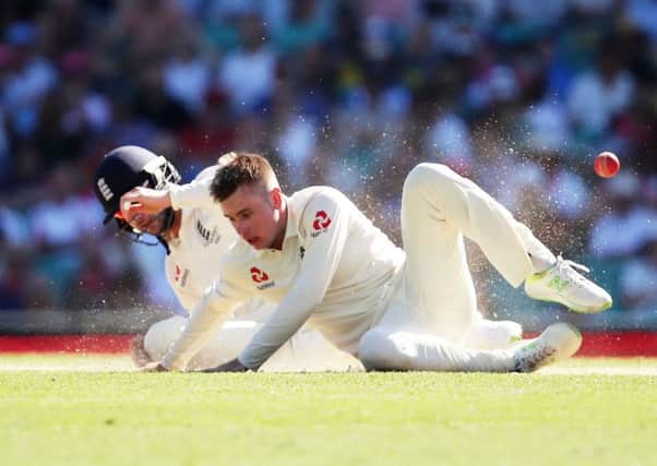 Mason Crane nearly collides with England team-mate Mark Stoneman as he attempts a catch. Picture: Getty.